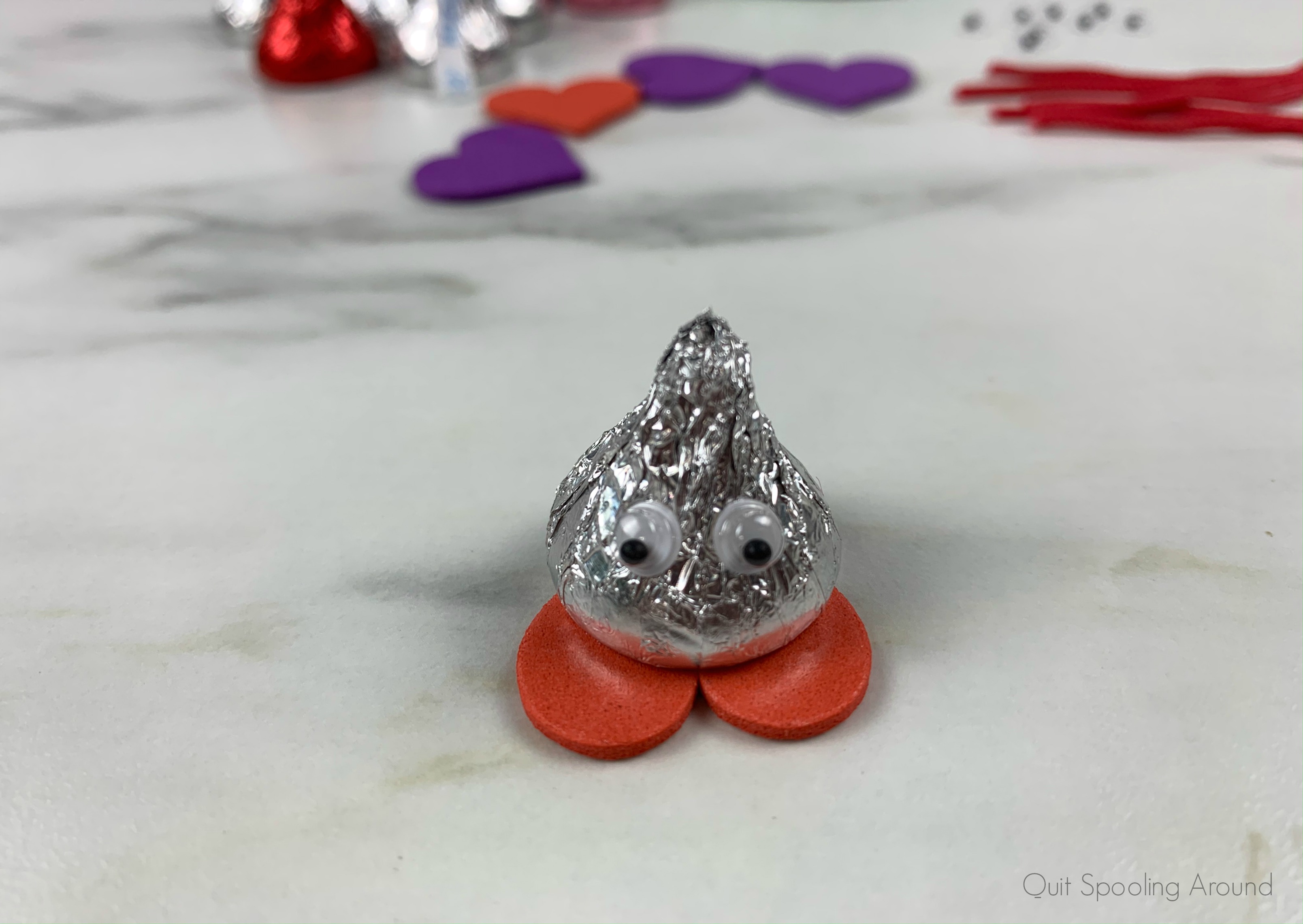 Add googly eyes to Hershey's Kiss